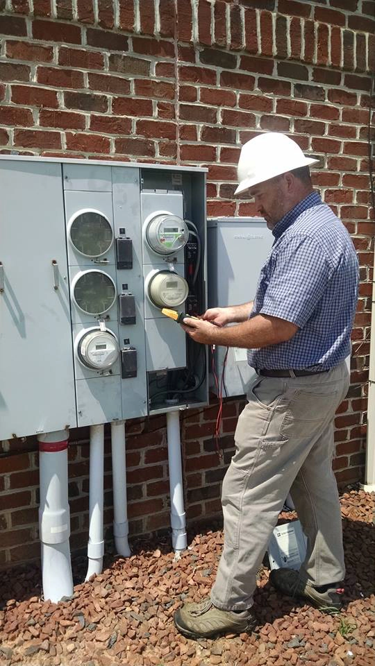 Electrician working on electric meter for house